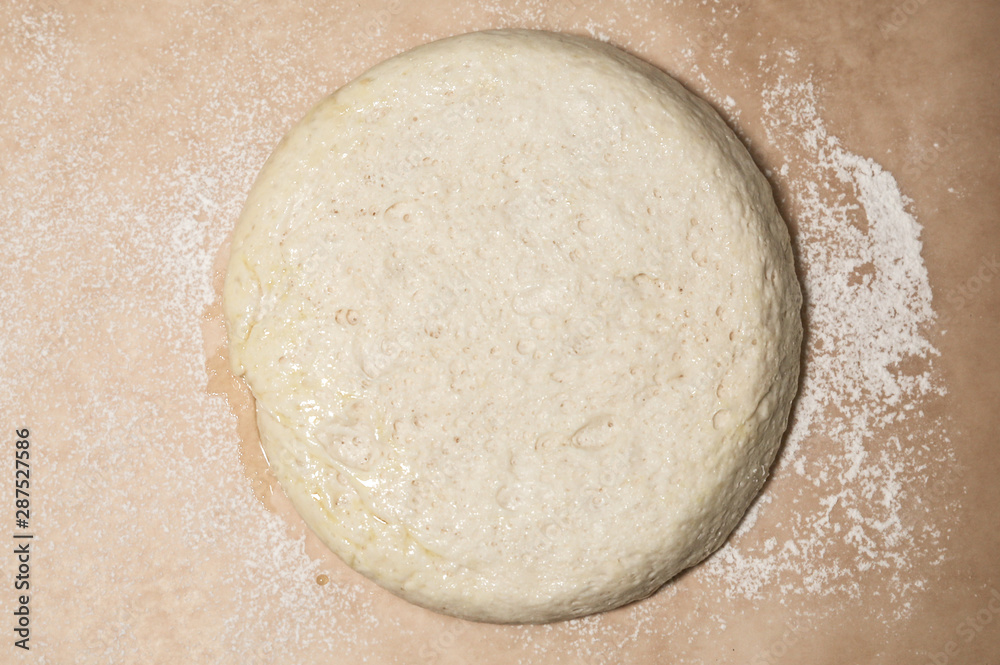 Yeast dough on the table. Baking concept. Cooking ideas. Homemade food. Knead flour and water. Yeast dough on the table. Baking concept. Cooking ideas. Homemade food. Knead flour and water.