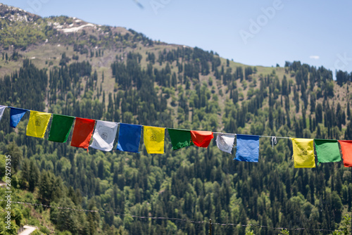 Budhist flags in the mountains near hamta photo