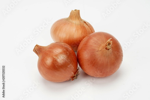 several ripe onions isolated on a light background