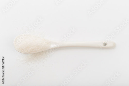 Spoon of fine granulated sugar isolated on white  - Image photo