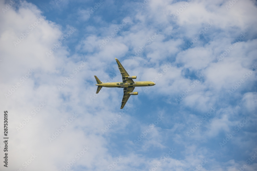 Big passenger plane flying in the cloudy sky