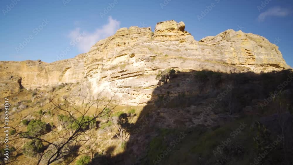 Isalo National Park, Madagascar. Clouds in the sky above the famous rock formation with grass plain on the foreground. Isalo National Park, Madagascar. Clouds in the sky above the famous rock formation with grass plain on the foreground.