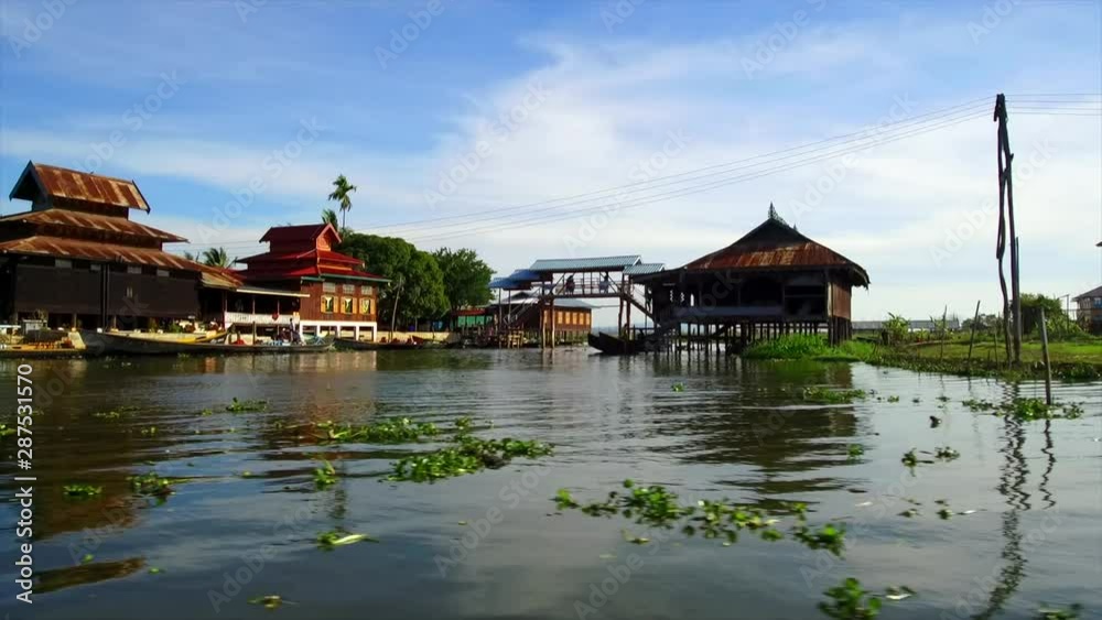Inle lake Shan State Myanmar.Floating Gardens and Villages. Commerce and Trade primarily by Long Boats. Surreal vision with mountainous backdrops. Inle lake Shan State Myanmar.Floating Gardens and Villages. Commerce and Trade primarily by Long Boats. Surreal vision with mountainous backdrops.