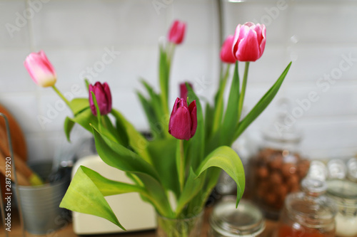 Bouquet of tulips on the kitchen background.