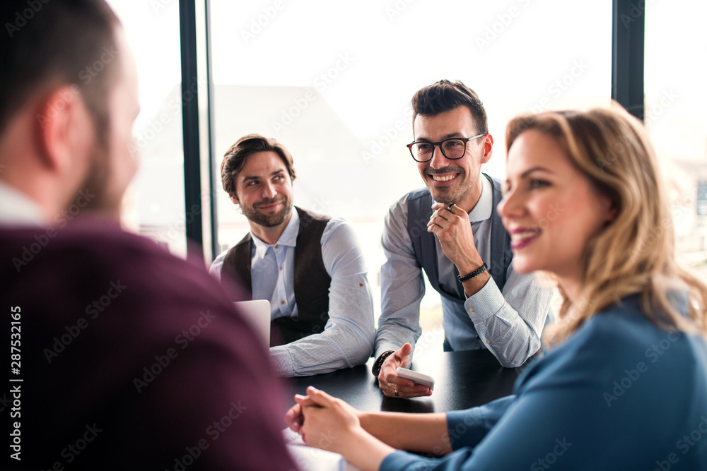 © Halfpoint - A group of young business people sitting in an office, having meeting. © Halfpoint - A group of young business people sitting in an office, having meeting.