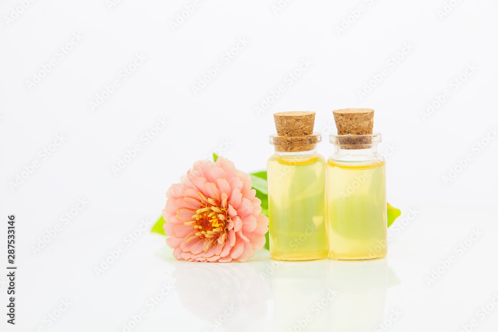 Zinnia essential oil in  beautiful bottle on White background