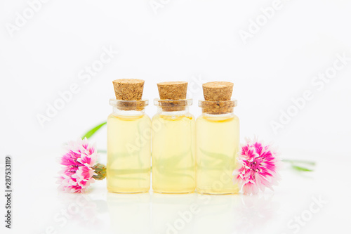 Essence of lavender flowers on White background in beautiful glass Bottle