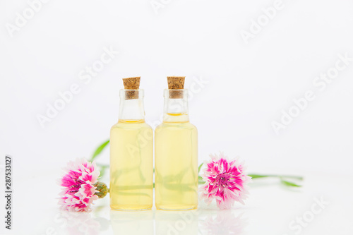 Essence of lavender flowers on White background in beautiful glass Bottle