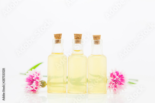 Essence of lavender flowers on White background in beautiful glass Bottle