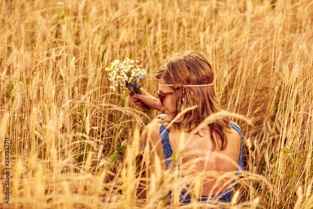 Woman with bouquet of flowers in a wheat field. Woman with bouquet of flowers in a wheat field.