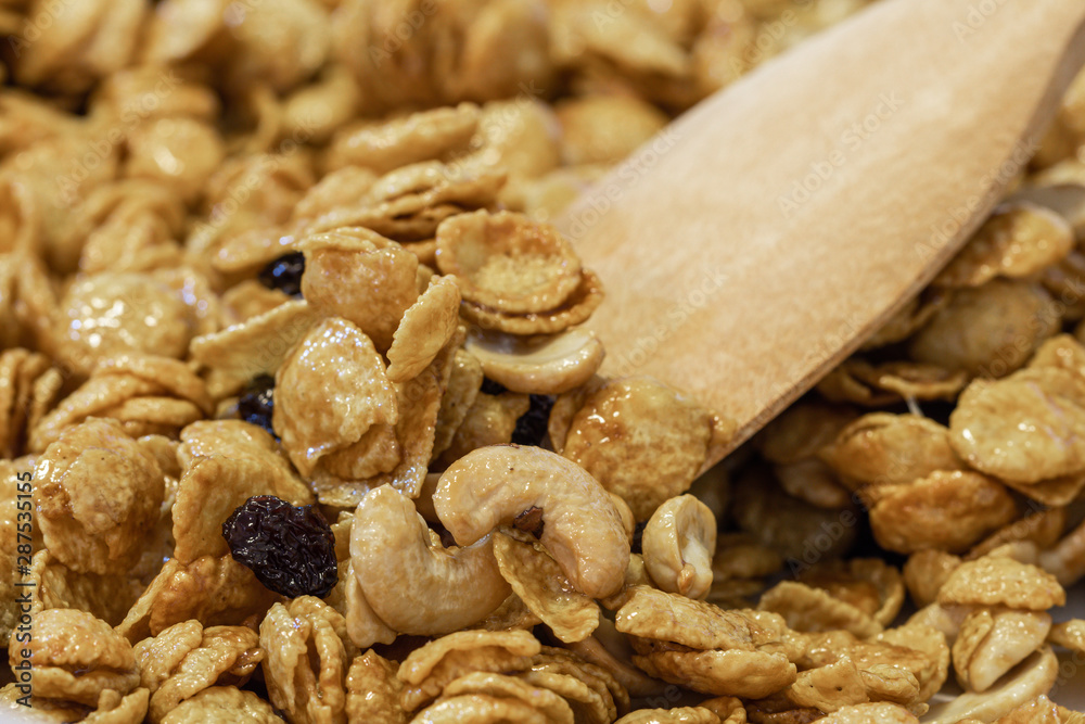 Obraz premium Close up delicious cereal caramel cornflakes warm tone background. A Breakfast cereal made by flakes of corn.