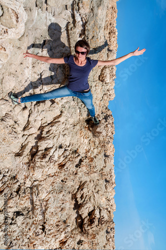 Active girl on a cliff without insurance