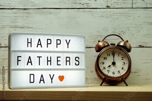 Happy Fathers Day word on light box and alarm clock