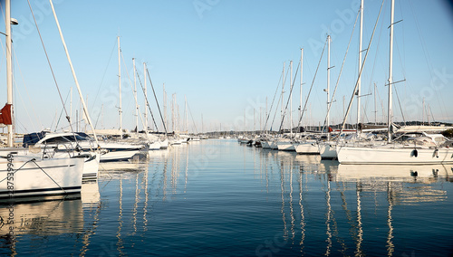 many luxury moored sailing yachts in the seaport, the concept of a summer vacation, a luxurious lifestyle and wealth