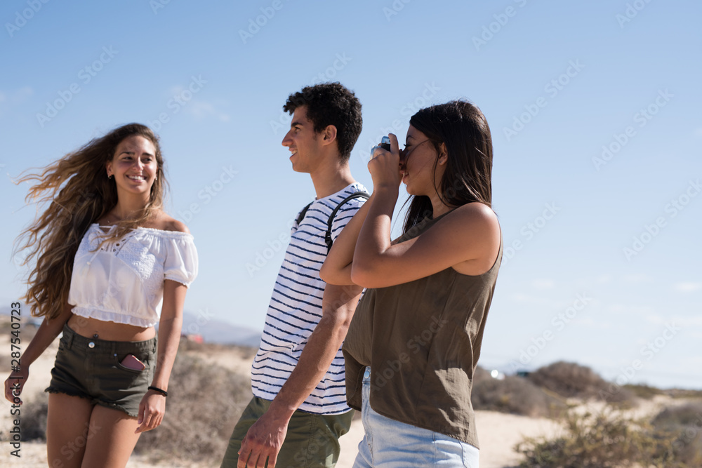 Three young people posing for the camera Three young people posing for the camera