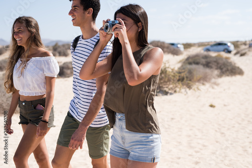 Young people walking on the beach and laughing