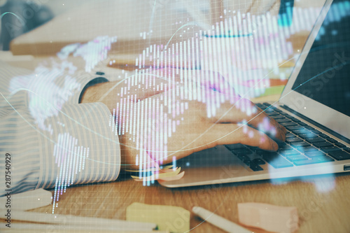 Multi exposure of businessman working on laptop on background. International business hologram in front. Concept of success.