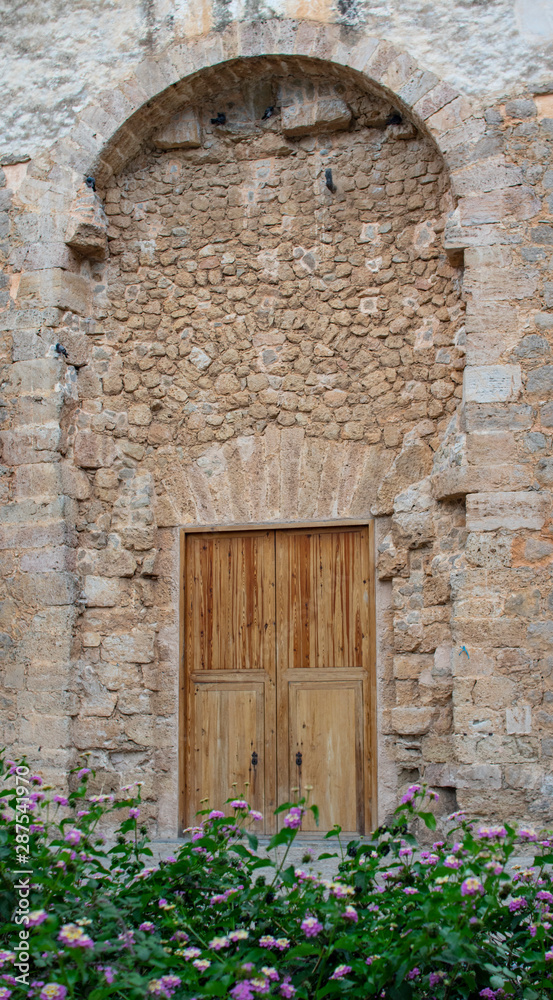 Fototapeta premium old wooden door in stone wall