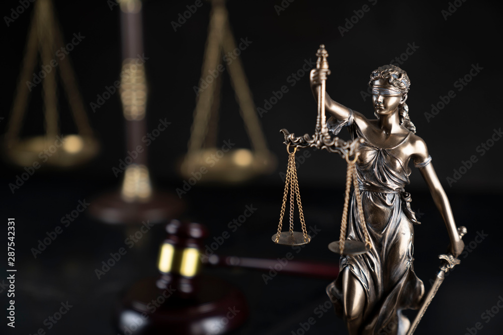 Law and justice theme. Gavel of the judge, Themis statue and the scale on the dark background. Law and justice theme. Gavel of the judge, Themis statue and the scale on the dark background.