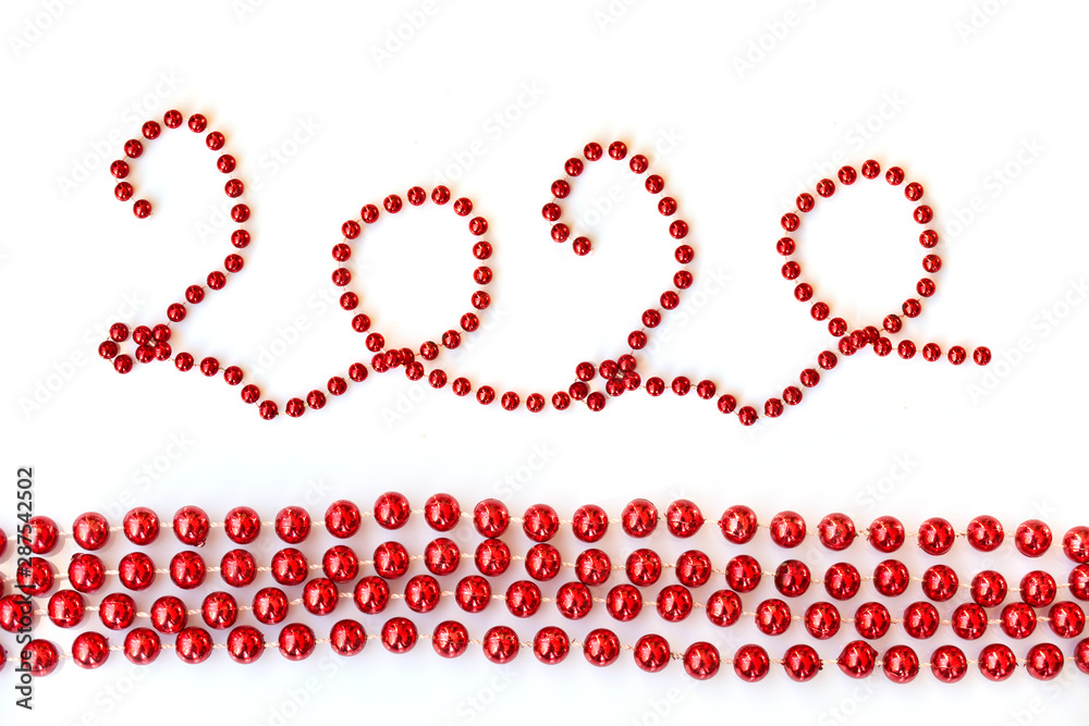 2020, red christmas tinsel beads ornament isolated on white background 2020, red christmas tinsel beads ornament isolated on white background