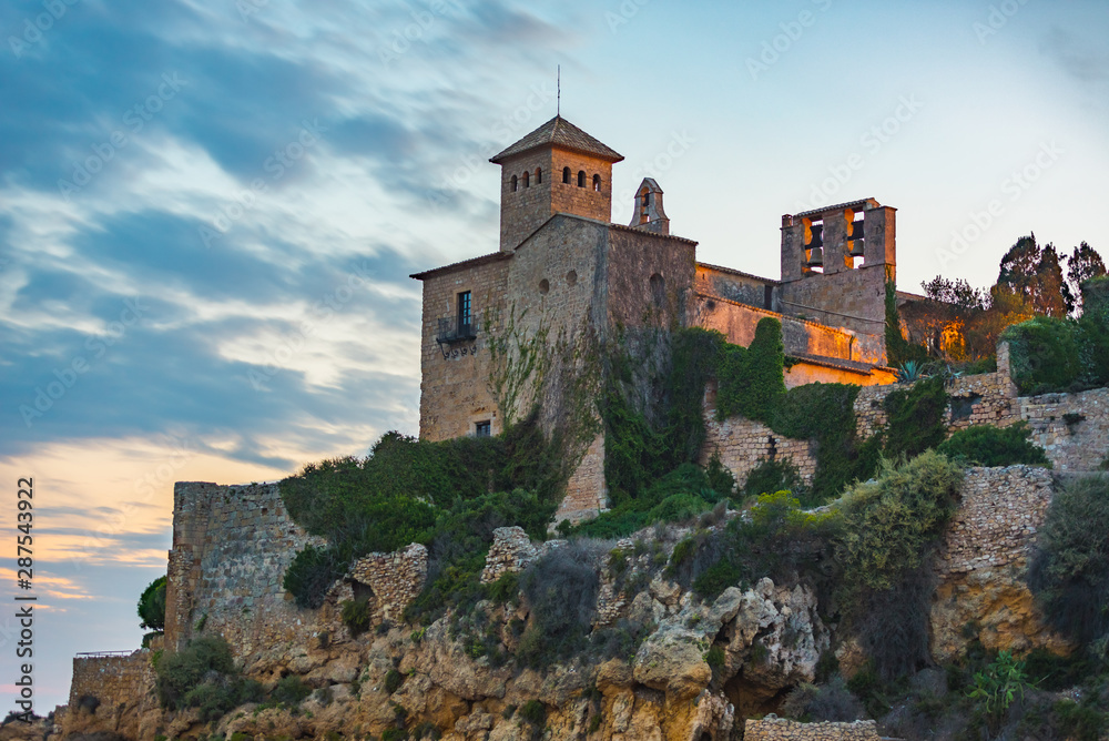 Castle of Tamarit seen from the beach on the sunset, Tarragona province, Catalonia, Spain.