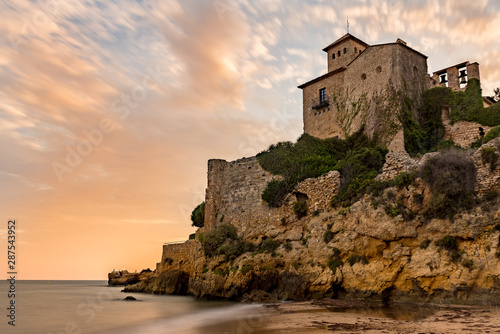 Castle of Tamarit seen from the beach on the sunset, Tarragona province, Catalonia, Spain.