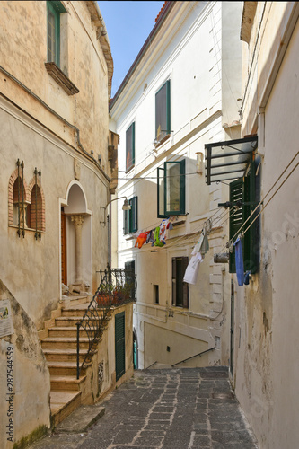 The narrow street among the old houses of the town of Amalfi in Italy