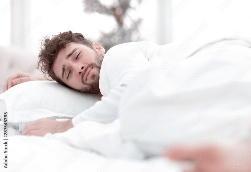 closeup.the tired men sleep soundly on the bed closeup.the tired men sleep soundly on the bed