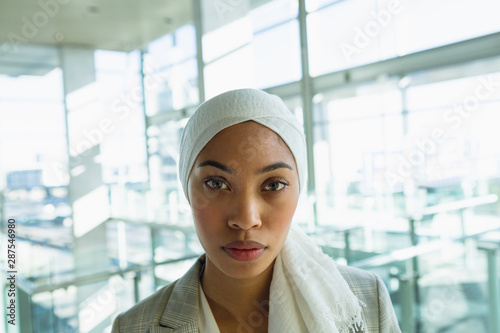Businesswoman in hijab looking at camera in a modern office