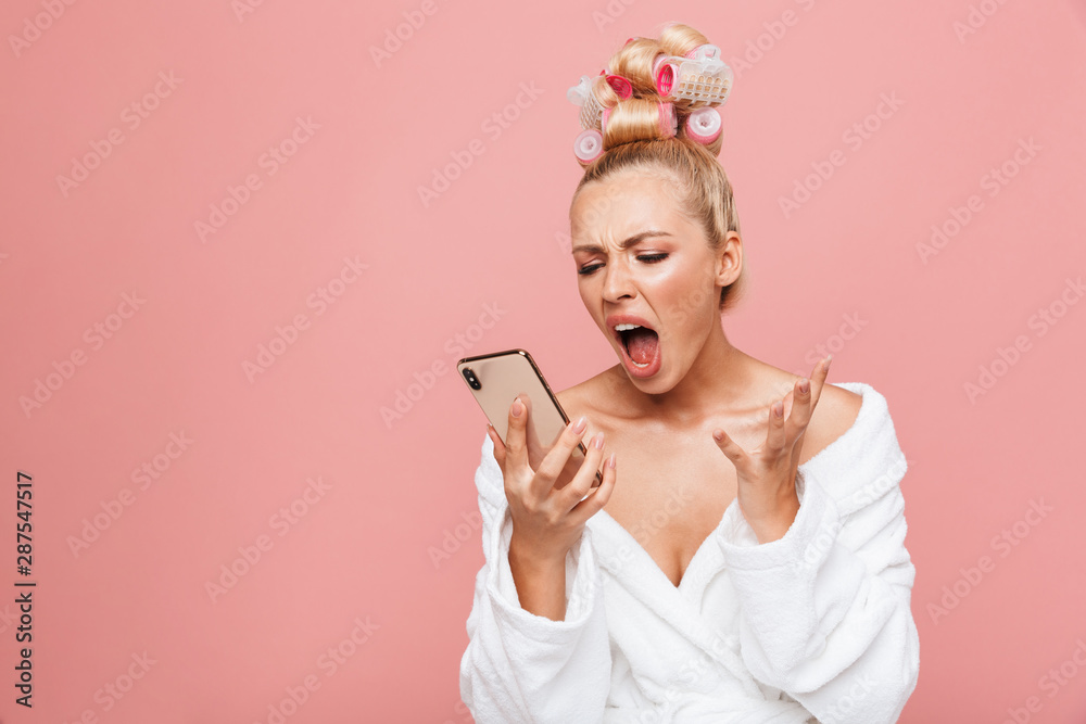 Beautiful young blonde girl wearing bathrobe standing Beautiful young blonde girl wearing bathrobe standing