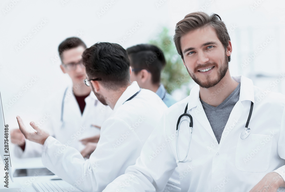 confident therapist, on the background of his colleagues confident therapist, on the background of his colleagues