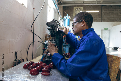 Middle aged man working in a sports equipment factory photo