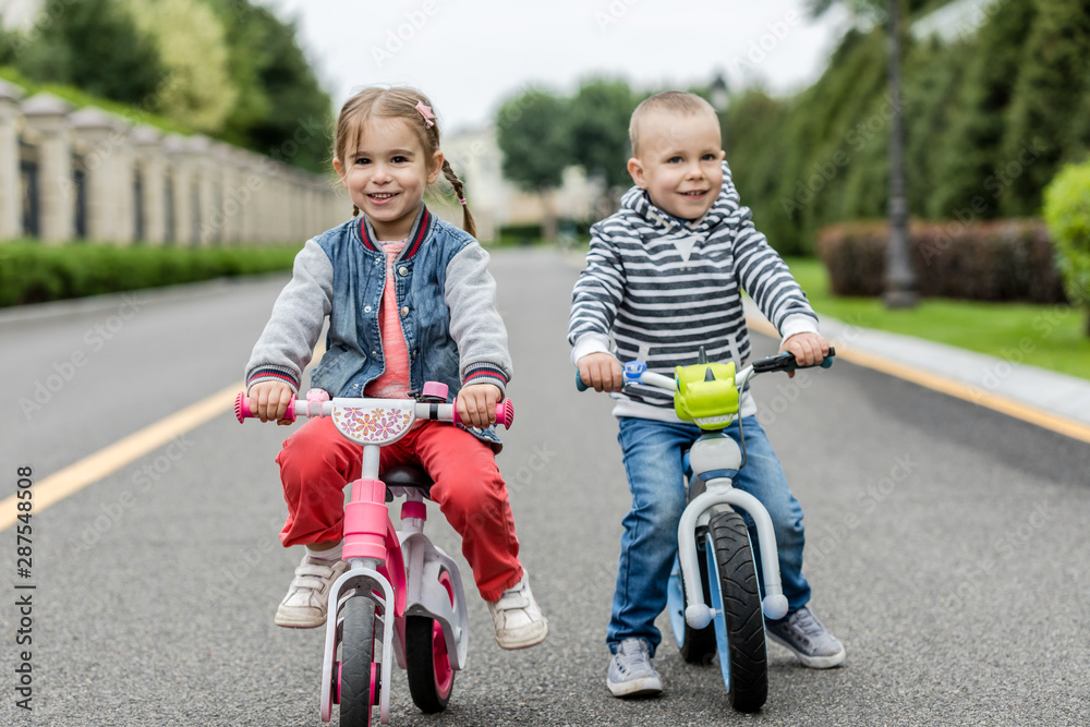 Happy kids with bikes having fun on the road at the day time. Happy kids with bikes having fun on the road at the day time.