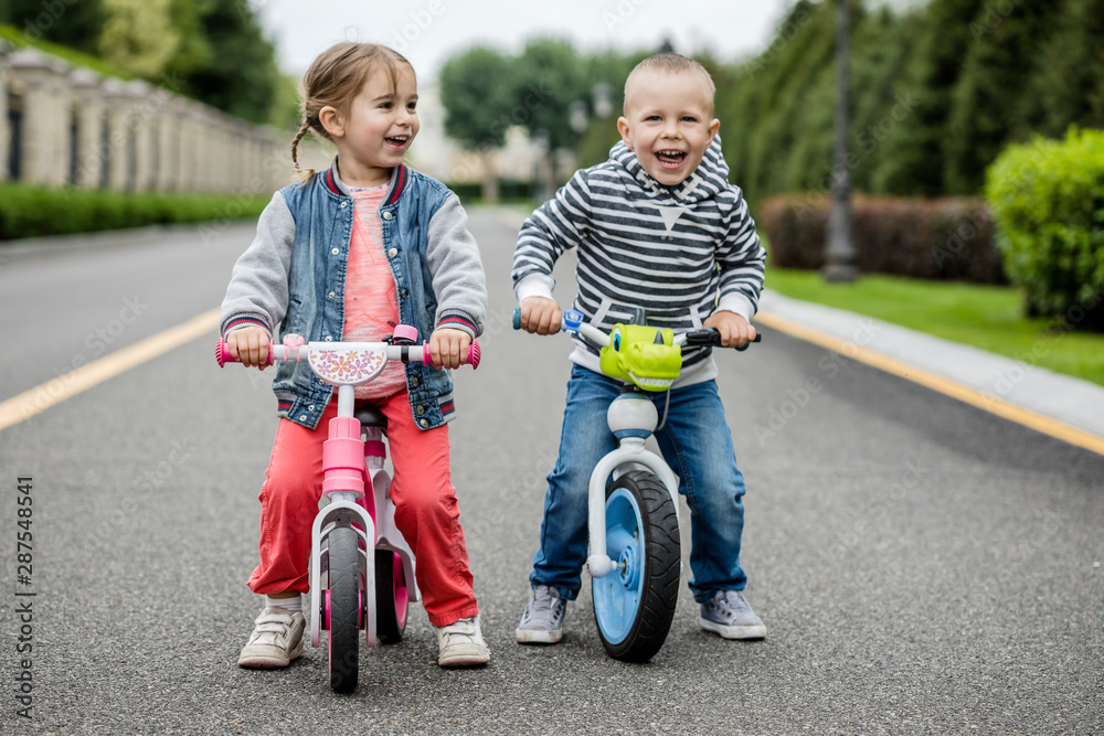 Happy kids with bikes having fun on the road at the day time. Happy kids with bikes having fun on the road at the day time.