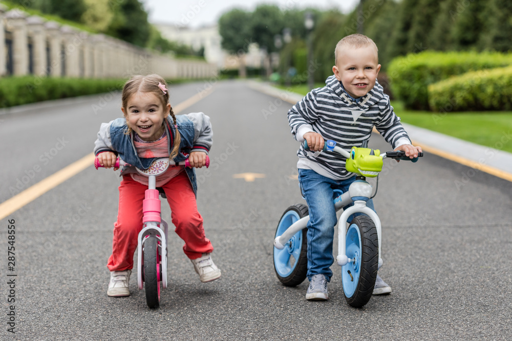 Happy kids with bikes having fun on the road at the day time. Happy kids with bikes having fun on the road at the day time.