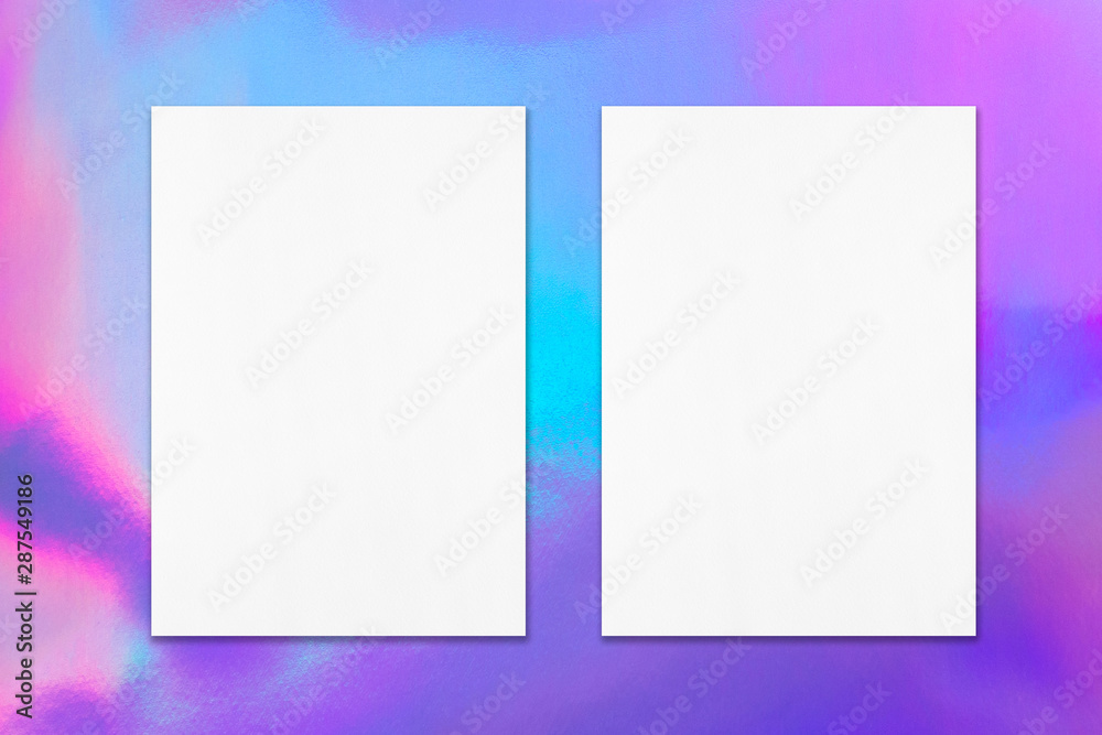 Two empty white vertical rectangle poster mockup with soft shadow on holographic background. Flat lay, top view