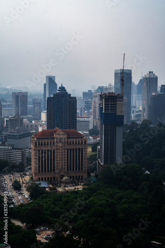 Aerial drone view of Kuala Lumpur city skyline during cloudy day  Malaysia