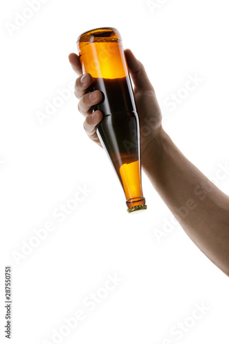 male hand holding brown beer bottle without label isolated on white background