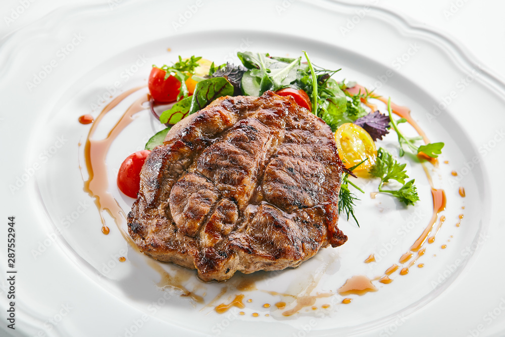 Pork Neck Steak with Mixed Salad on White Restaurent Plate Pork Neck Steak with Mixed Salad on White Restaurent Plate