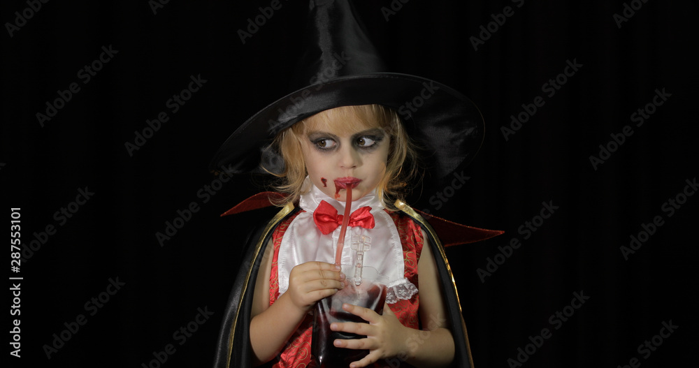 Dracula child. Girl with halloween make-up. Vampire kid with blood on her face