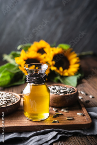 Sunflower oil in a glass jar, decorated with whole seeds and flowers