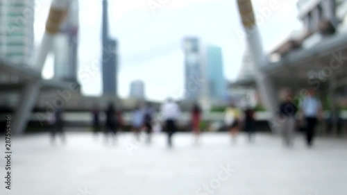 Blurred of people walking on the Skywalk on business district in metropolis of Bangkok city, blurred people moving background