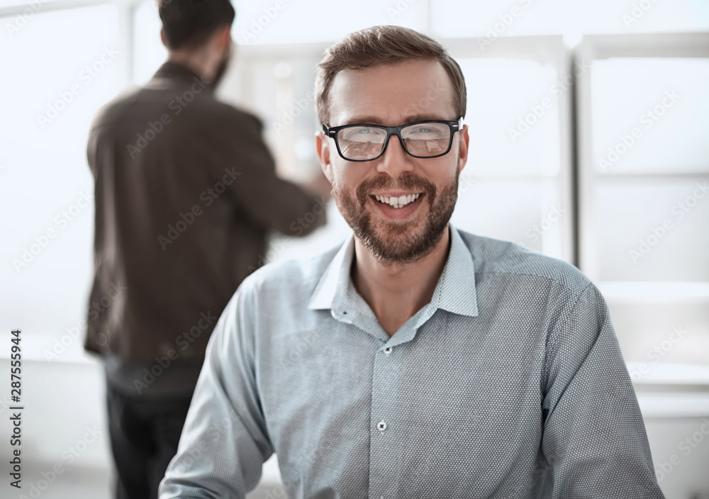 friendly business man sitting at his Desk friendly business man sitting at his Desk