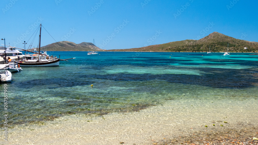 Clear amazing azure coloured sea water with granite rocks in Capriccioli beach, Sardinia, Italy.