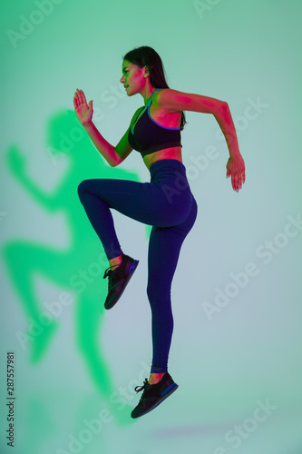 Strong fitness woman running isolated with led flash lights.
