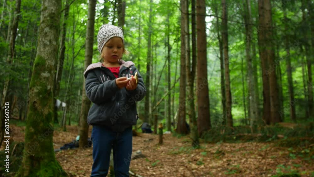 Child girl found a mushroom in the forest Child girl found a mushroom in the forest