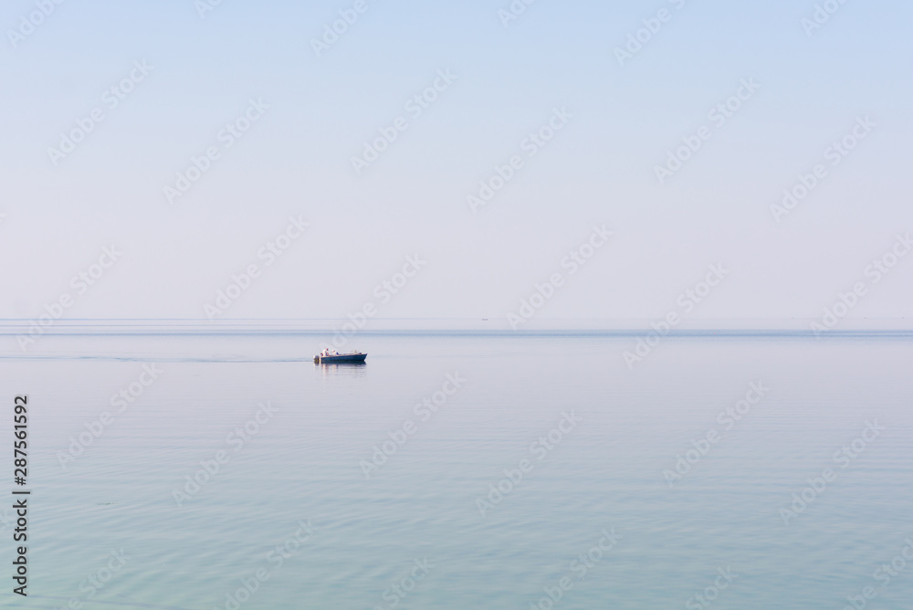 Fishermen in a boat on the lake. Fishermen in a boat on the lake.