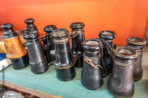 Antique Binoculars Sitting in a Row on a Shelf