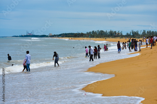 people enjoyning at mahabalipuram beach in summer in tamil nadu india