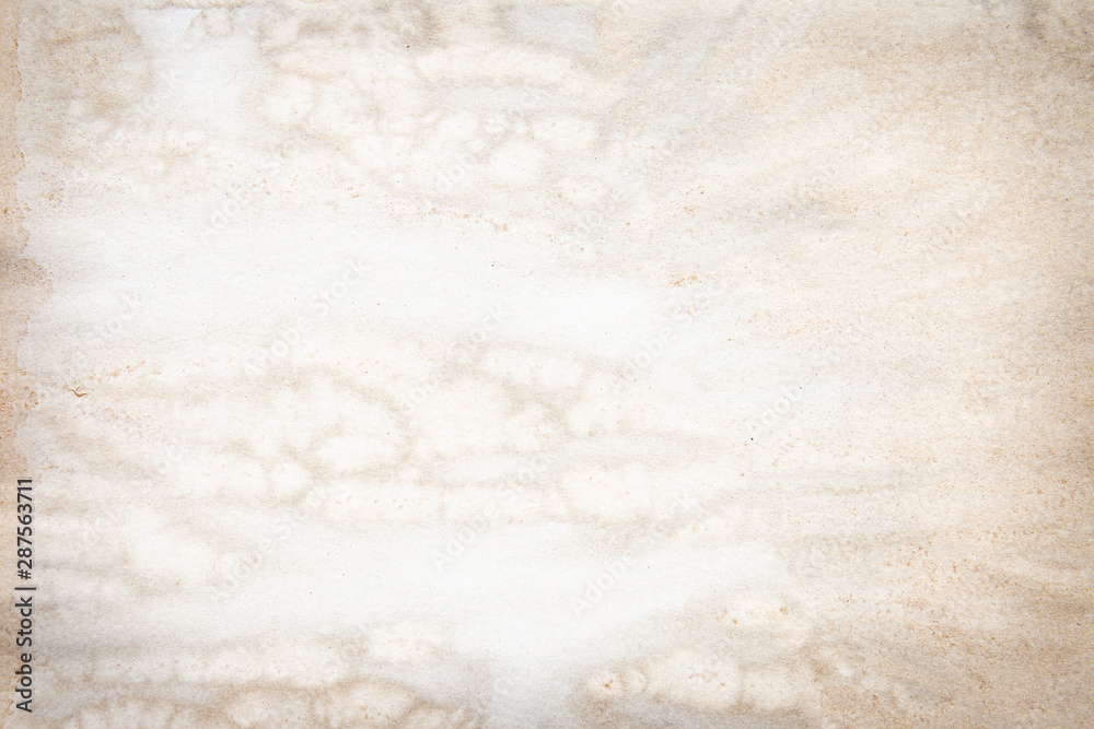 Obraz premium Old brown and white paper stained with coffee. Vintage abstract background.